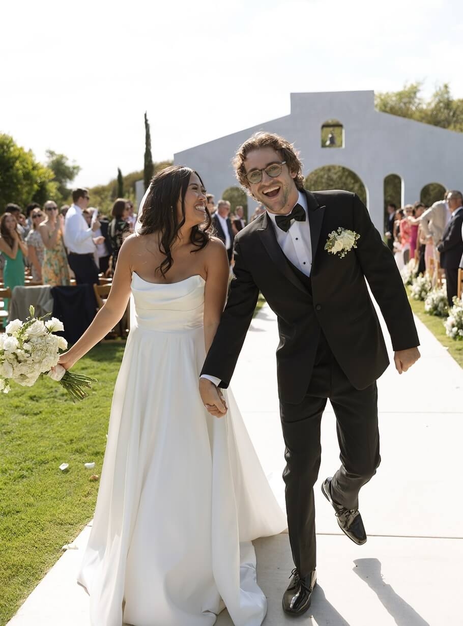 Сouple wearing a white gown and a black suit
