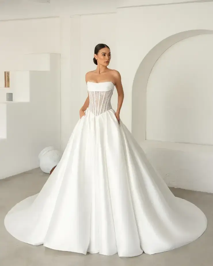 model is wearing a strapless ball gown wedding dress